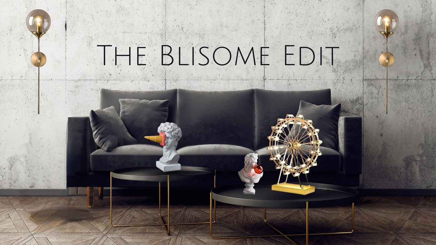 Modern living room with gray sofa, decorative items, and 'The Blisome Edit' text.